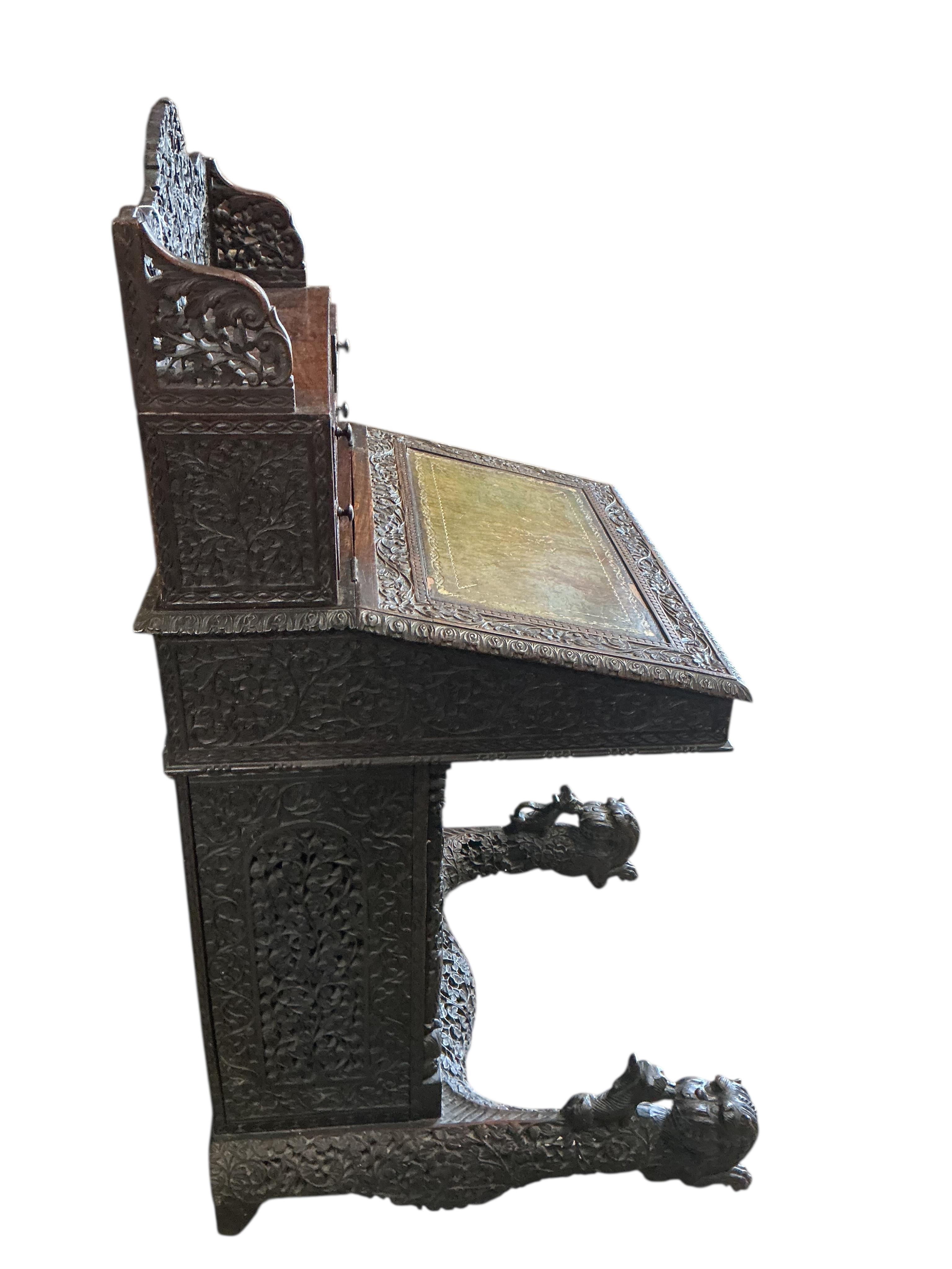 A 19th century Burmese carved hardwood Davenport, width 65cm, depth 67cm, height 122cm